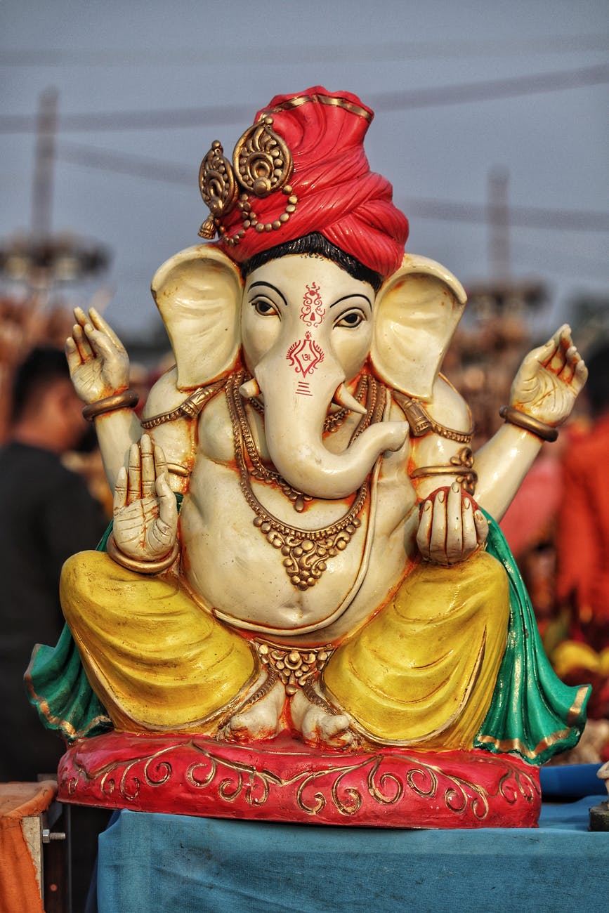 gold and red hindu deity figurine