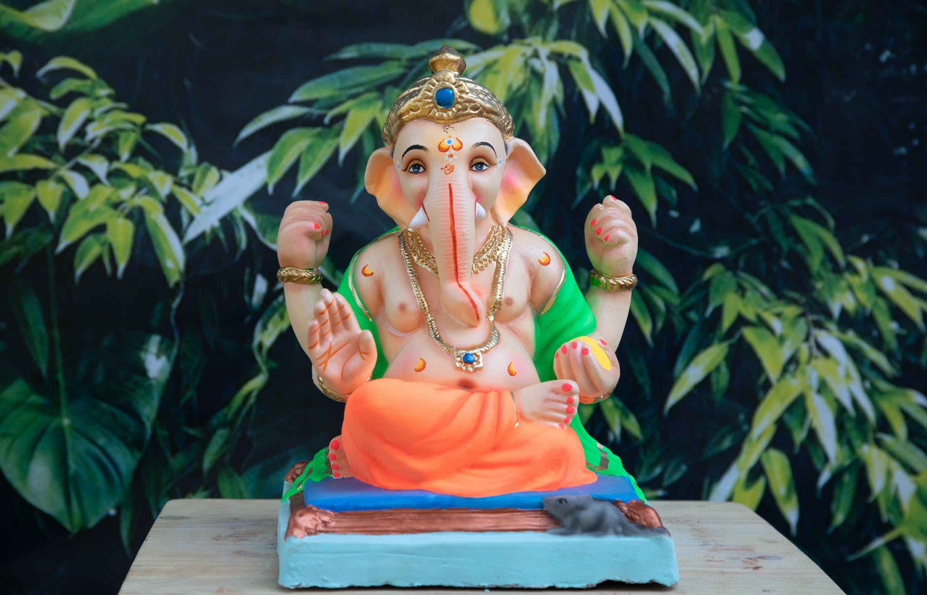 elephant headed deity figurine on brown wooden table top