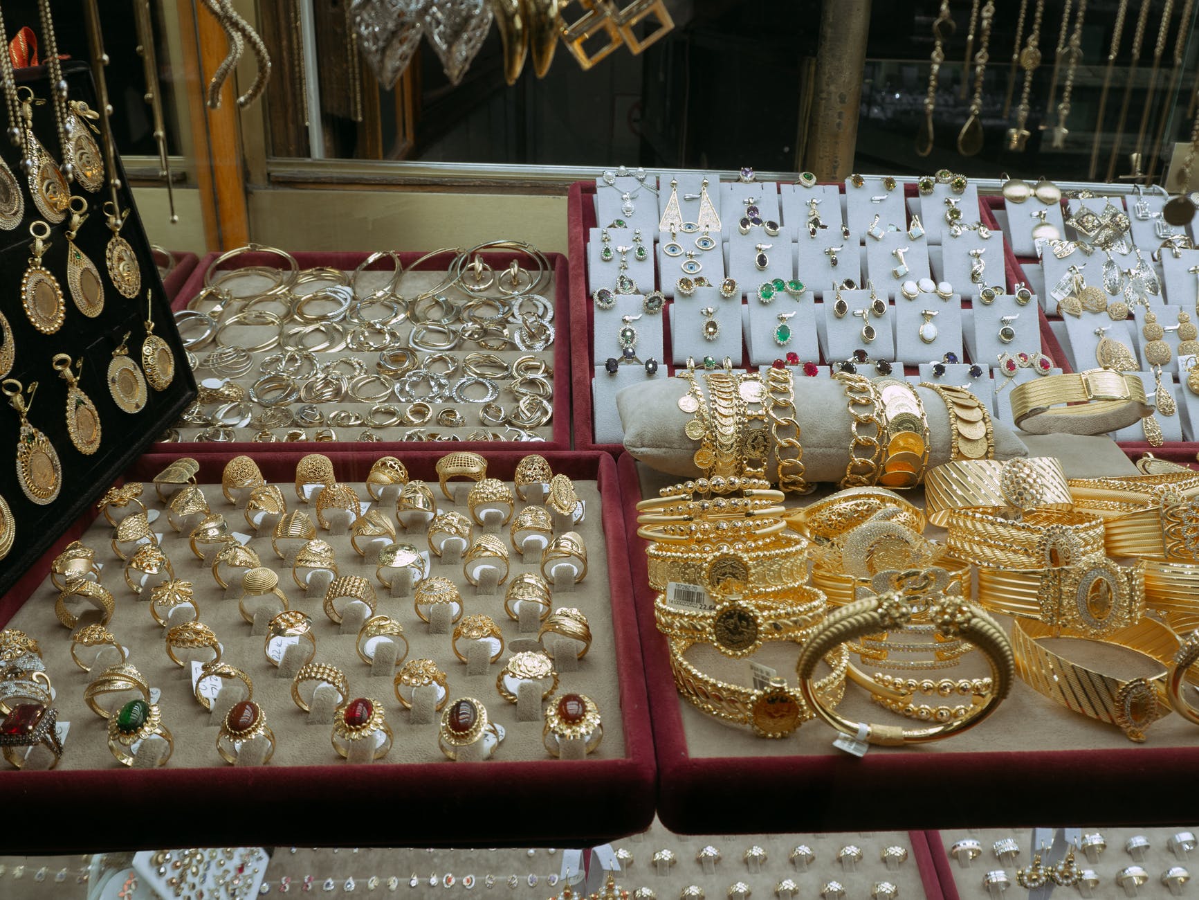 gold and silver round coins on pink box
