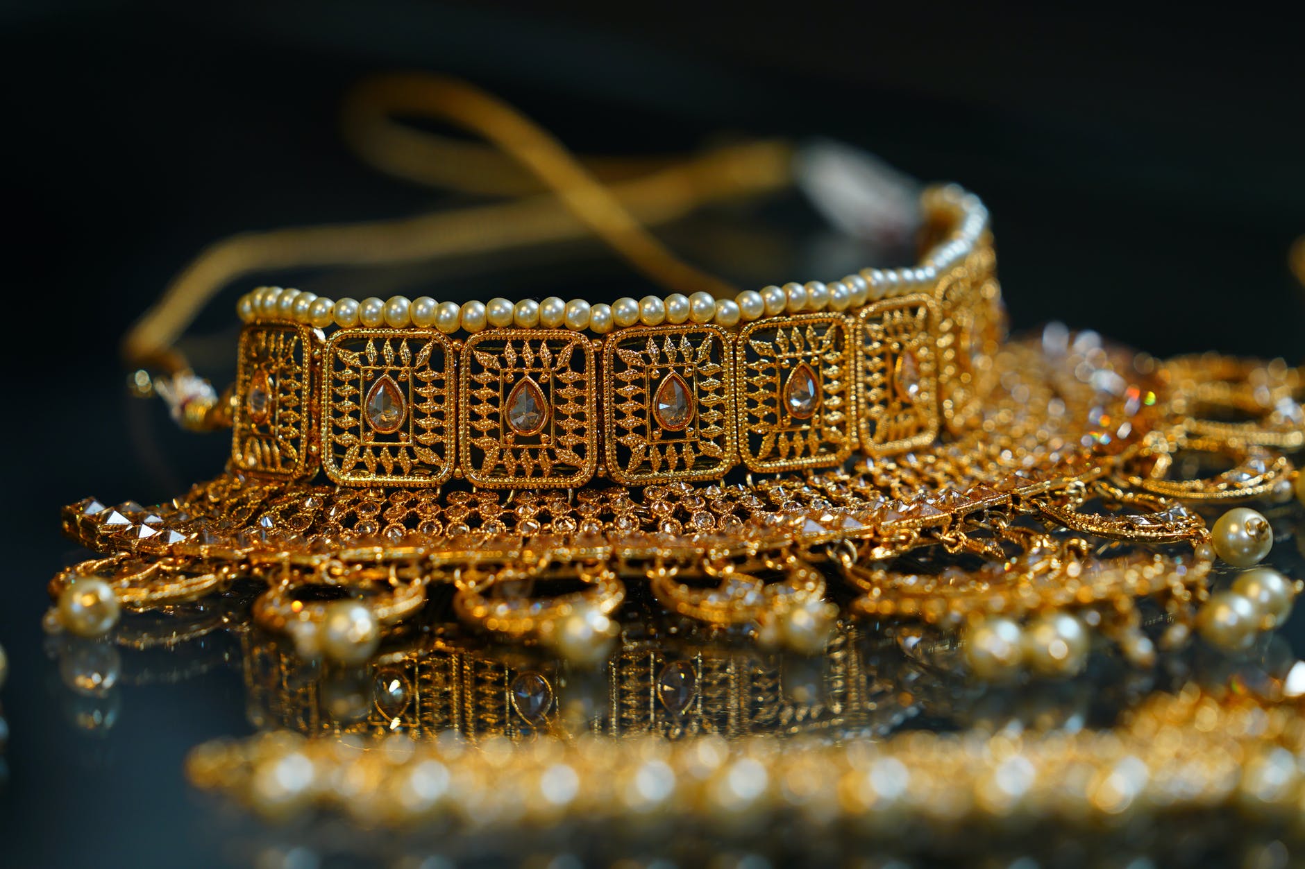 golden precious oriental jewelry placed on table